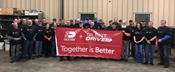 Dexter Silent Drive employees with banner